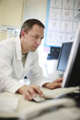 Pathologist using laptop