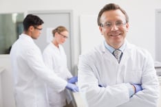 Doctor standing with arms folded while training todays pathologists